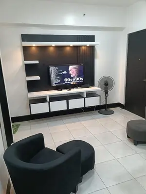 a living room with a flat screen tv on a wall at A place to relax & have privacy in Manila
