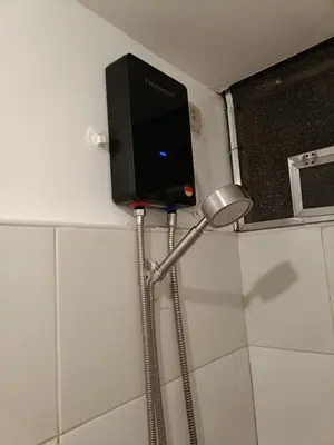 a shower head and a lamp in a bathroom at A place to relax & have privacy in Manila