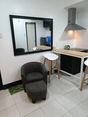 a room with a chair and a desk and a mirror at A place to relax & have privacy in Manila