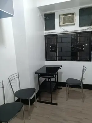 a room with a table and chairs and a window at A place to relax & have privacy in Manila
