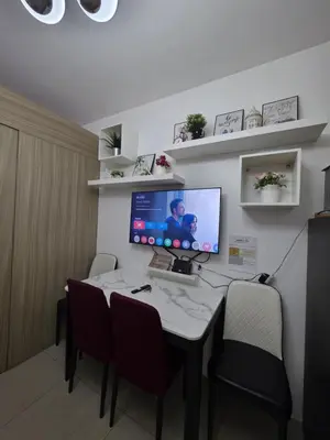 a room with a desk with a computer on it at Ethans Place in Manila