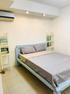 a bedroom with a blue bed in a room at He Condotel Blessed in Manila