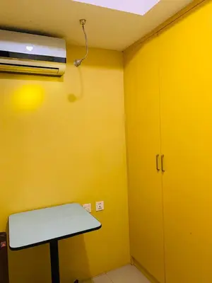 a room with a table and a ceiling fan at He Condotel Blessed in Manila