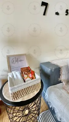 a basket filled with food and a book next to a bed at 2BR condo Azure Netflix, Karaoke & Board games in Manila