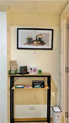 a shelf in a room with a picture on the wall at 2BR condo Azure Netflix, Karaoke & Board games in Manila