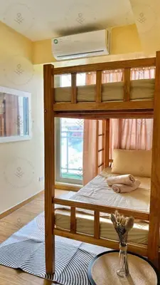 a bedroom with two bunk beds with a vase on the floor at 2BR condo Azure Netflix, Karaoke & Board games in Manila