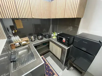 a small kitchen with a sink and a microwave at Casa Amaya RNR Transient House in Tanza