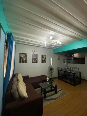 a living room with a couch and a table at Casa Amaya RNR Transient House in Tanza