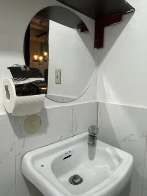 a bathroom with a sink and a mirror at Casa Amaya RNR Transient House in Tanza