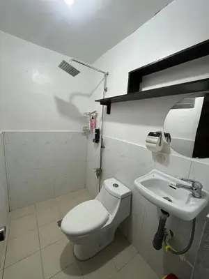 a bathroom with a toilet and a sink at Casa Amaya RNR Transient House in Tanza