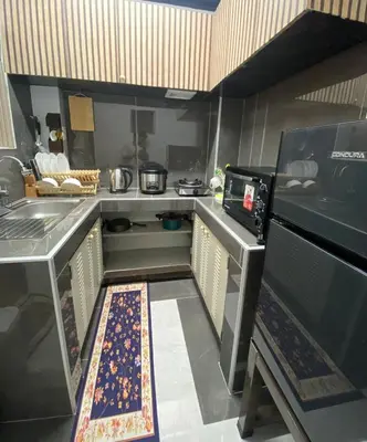 a small kitchen with a sink and a stove at Casa Amaya RNR Transient House in Tanza