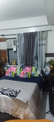 a bedroom with a bed with curtains on it at Florida sun condo in Dasmariñas