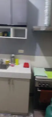 a kitchen with a white counter top and a stove at Florida sun condo in Dasmariñas