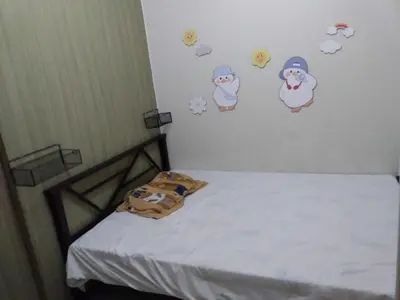 a bedroom with a bed with stickers on the wall at Breeze Residences in Manila