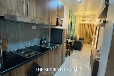 a kitchen with a sink and a counter top at The Shoreline Suite at Shore 3 Residences MOA Pasay in Manila