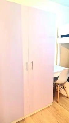 a white cupboard in a room with a desk at Veronica Grey's Staycation 1BR in Manila