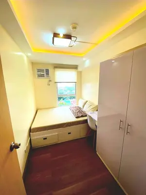 a small room with a bed and a window at Veronica Grey's Staycation 1BR in Manila