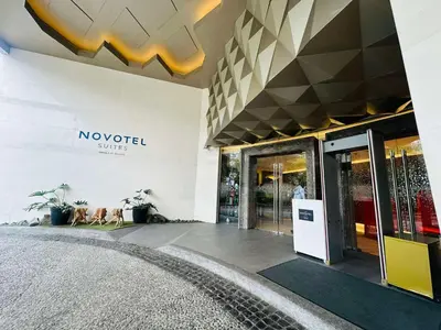 a building with a noordidated smiles sign on the wall at Novotel Executive Hotel at Rosalina Acqua Residence in Manila