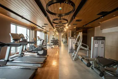 a gym with treadmills and cardio machines at Novotel Executive Hotel at Rosalina Acqua Residence in Manila