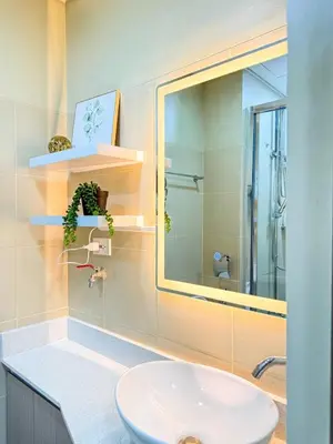 a bathroom with a sink and a mirror at Eastovia Suites city center condo with pool at Fame in Manila