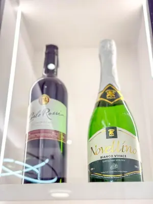 two bottles of wine sitting in a refrigerator at Eastovia Suites city center condo with pool at Fame in Manila