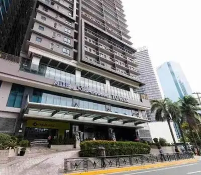 a tall building with a sign on the front of it at ADB Ortigas Tower in Manila
