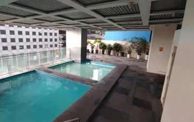 a swimming pool on top of a building at ADB Ortigas Tower in Manila