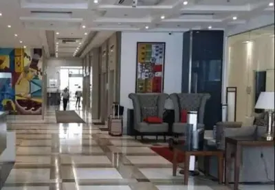 a lobby with chairs and tables in a building at ADB Ortigas Tower in Manila