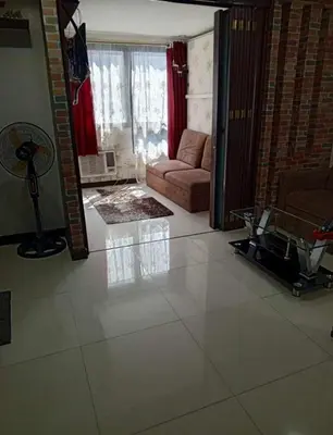 a living room with a couch and a table at ADB Ortigas Tower in Manila