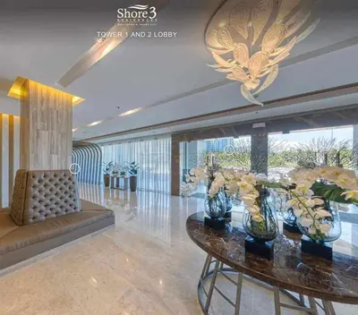 a lobby with a table with vases of flowers on it at StayWisePH at MOA in Manila