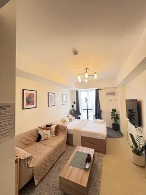 a hotel room with a bed and a couch at The Fresh Escape in Manila