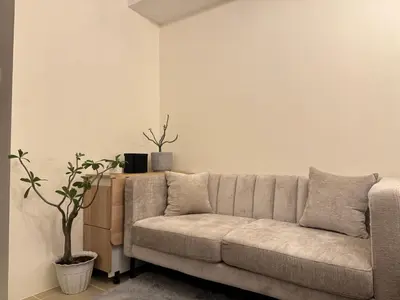 a living room with a couch and a plant at The Fresh Escape in Manila