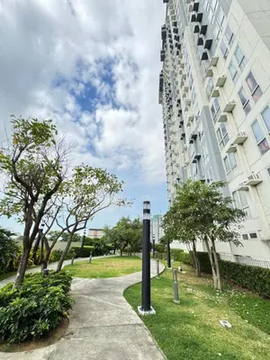 a building with a street light next to a sidewalk at The Fresh Escape in Manila