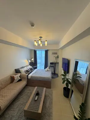 a living room with a bed and a couch at The Fresh Escape in Manila