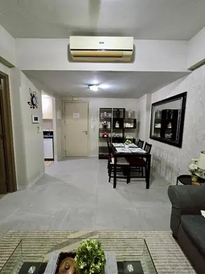 a living room with a table and a dining room at Newport 150 - 1 BR staycation near NAIA 3 in Manila