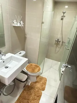 a bathroom with a toilet and a sink and a shower at Relaxing Pasay Retreat Pool & WiFi - Harlhy in Manila