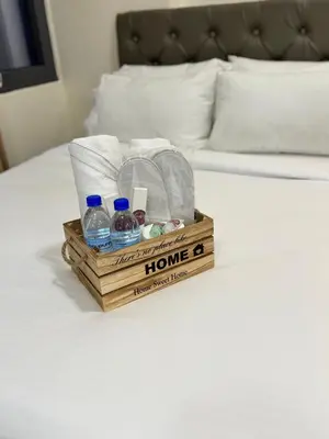 a wooden crate with bottles of water on a bed at Relaxing Pasay Retreat Pool & WiFi - Harlhy in Manila