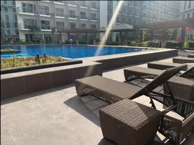 a pool with benches and a fountain in a building at C12F JRM Staycation Naia T3 Near Airport With Parking in Manila
