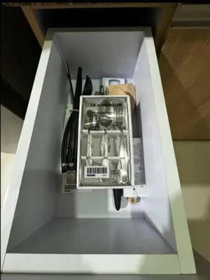 a white cabinet with a stove top oven with utensils at C12F JRM Staycation Naia T3 Near Airport With Parking in Manila