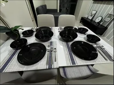 a table with black plates and utensils on it at C12F JRM Staycation Naia T3 Near Airport With Parking in Manila