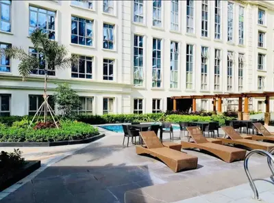 a building with tables and chairs in a courtyard at C12F JRM Staycation Naia T3 Near Airport With Parking in Manila
