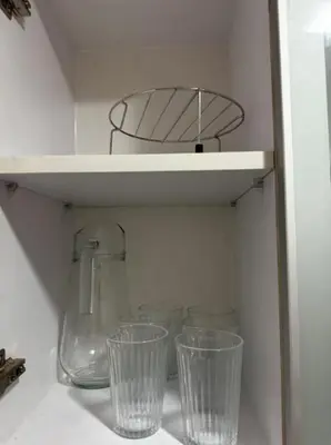 a row of glasses sitting on a shelf at C12F JRM Staycation Naia T3 Near Airport With Parking in Manila
