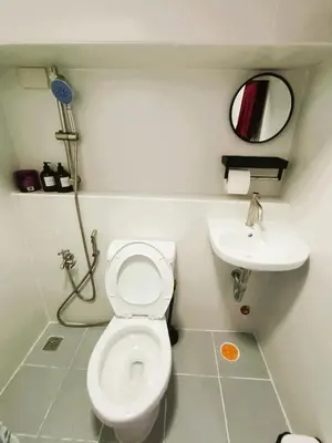 a bathroom with a toilet and a sink at Agate's Loft in Manila