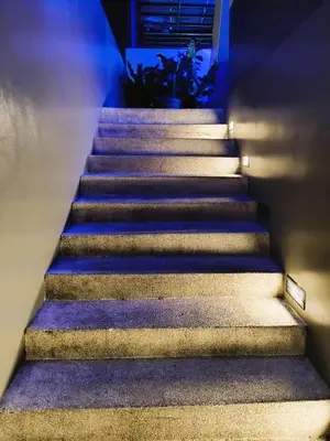 a set of stairs in a building with blue lights at Agate's Loft in Manila