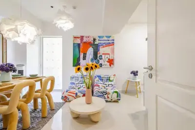 a living room with a vase of flowers on a table at Jing'sCrib 2BR Apartment by Azure Near Manila International Airport in Manila