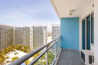a balcony with a view of some tall buildings at Jing'sCrib 2BR Apartment by Azure Near Manila International Airport in Manila