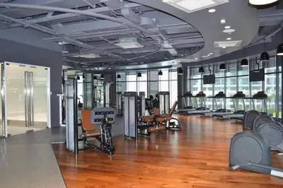 a gym with a lot of treadmills and machines at Jing'sCrib 2BR Apartment by Azure Near Manila International Airport in Manila