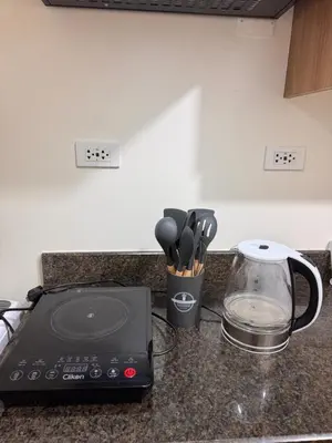 a kitchen counter with a blender and a toaster at Apartment in KAI Garden Residences in Manila