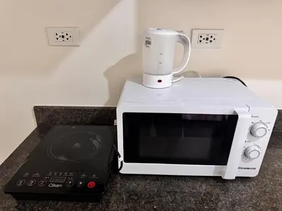 a white blender sitting on top of a microwave at Apartment in KAI Garden Residences in Manila