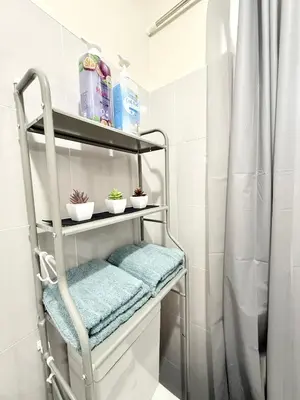 a towel rack in a bathroom with a shower at Maiko Happy Studio near US Embassy in Manila